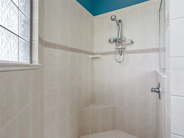 Primary Bath with tiled Roman shower and a bench