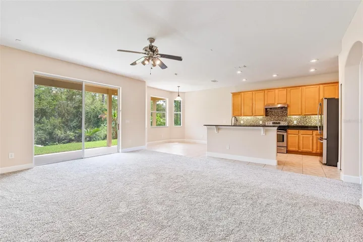 The spacious family room open up to the kitchen and offers serene conservation views.