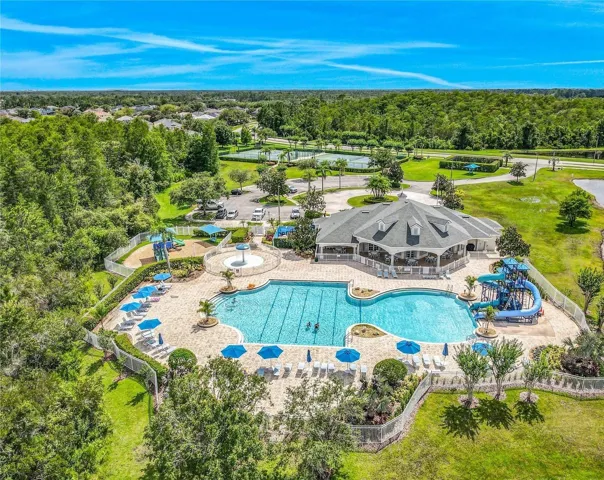 Resort style lap pool with water slide.