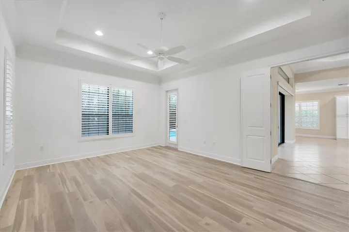 Primary Bedroom Features Tray Ceiling & Crown Molding
