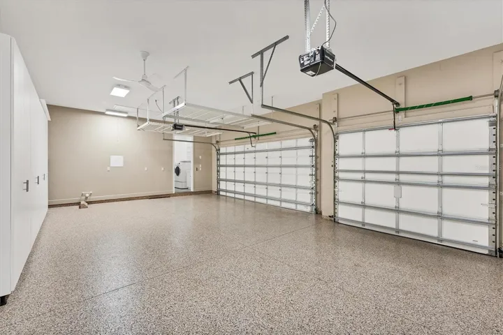 3 Car Garage Features Built-in Cabinets & Storage Racks
