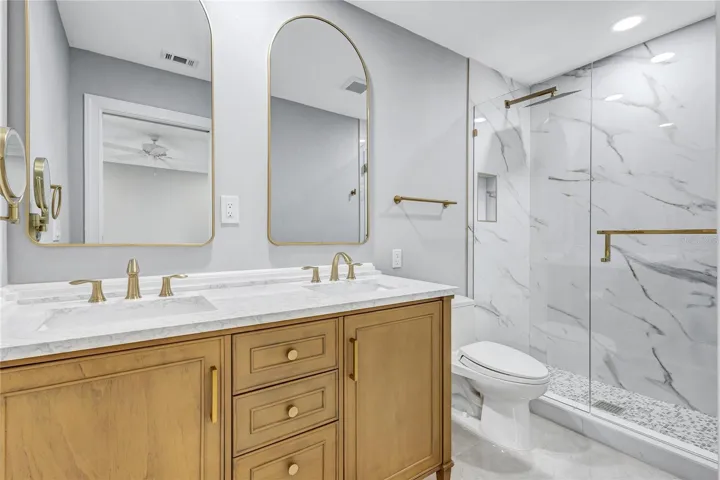 Primary bedroom ensuite with dual sinks and quartz countertops