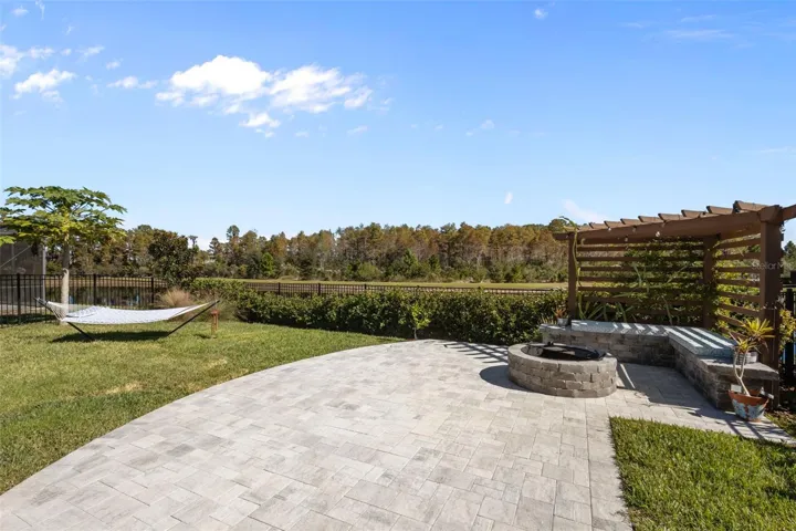Updated backyard with pavered patio, fire pit and pergola