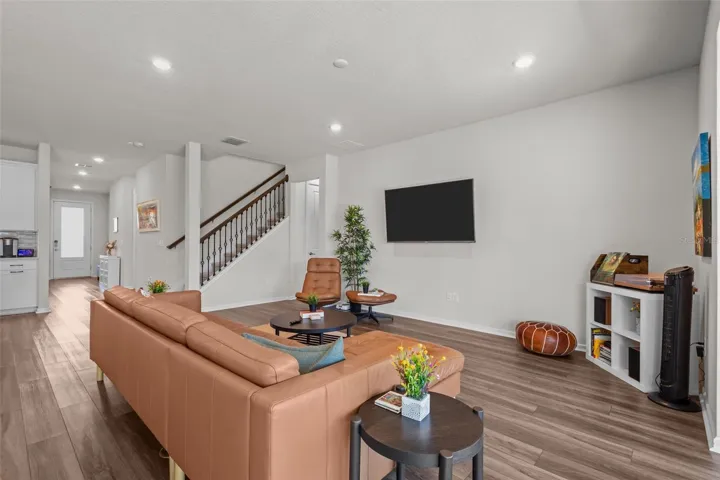 Living RoomThe main living area features luxury vinyl plank flooring, great natural light, and peaceful backyard views.