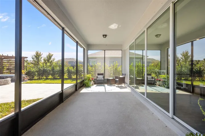 Screened LanaiScreened lanai overlooks the fenced backyard, pond, and conservation area.