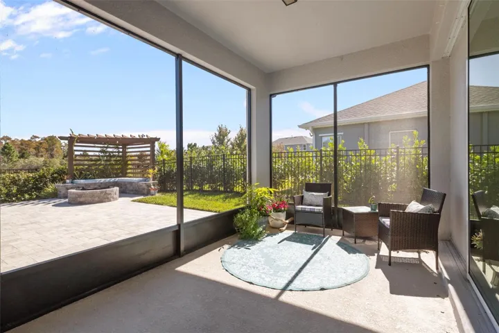 Screened LanaiScreened lanai overlooks the fenced backyard, pond, and conservation area.