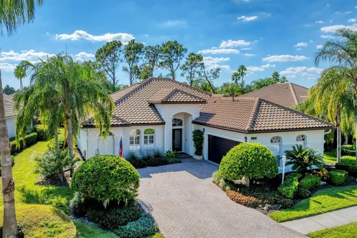 The dark brown two-car garage door adds contrast and sophistication to the façade.