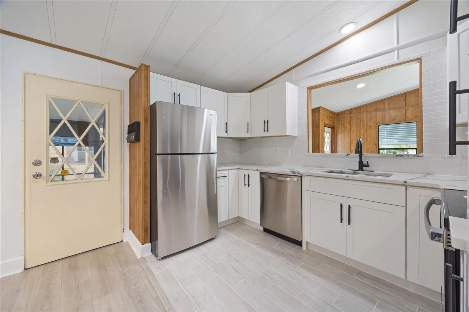 Newly Remodeled Titled Kitchen With A Door To The Hall Connecting Your Laundry Room And Carport