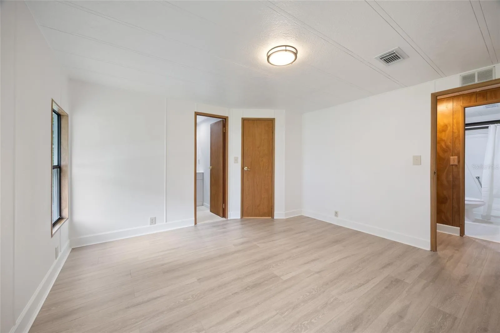 Large Master Bedroom With A Private Bathroom And Walk-In Closet