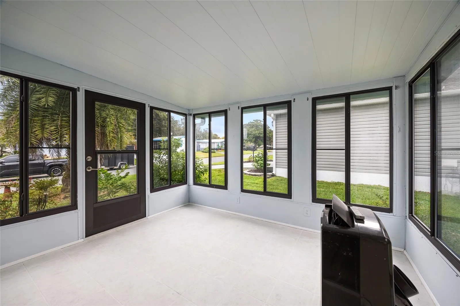 Enclosed Tiled Lanai With A View Of Your Landscaping