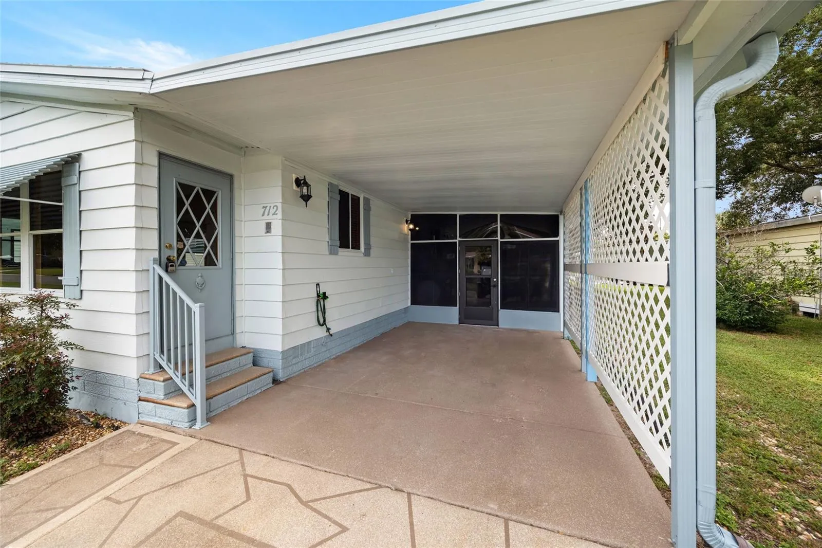 The Attached Carport And Painted Driveway