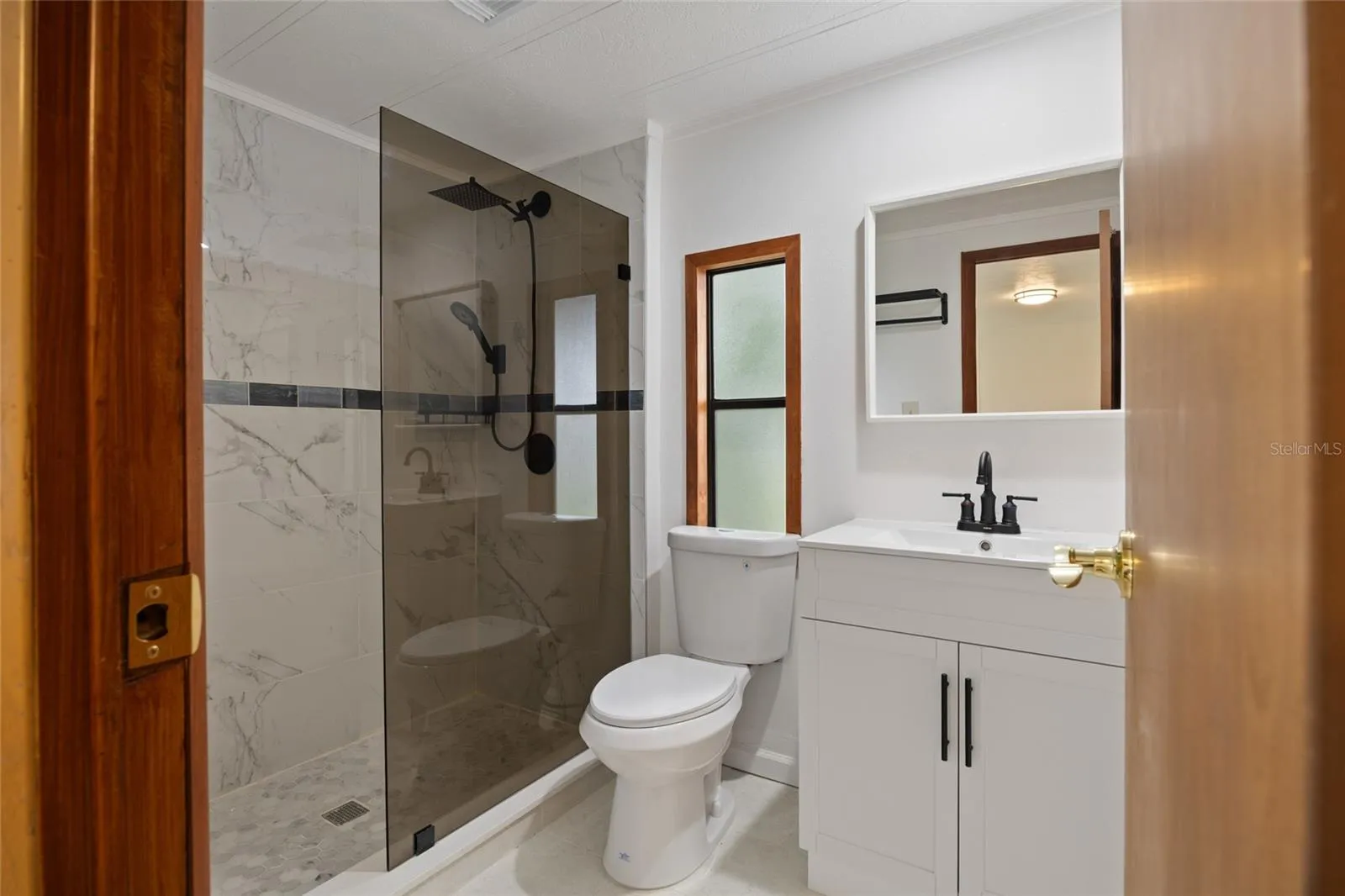 Remodeled Tiled Master Bathroom With A Walk-In Shower