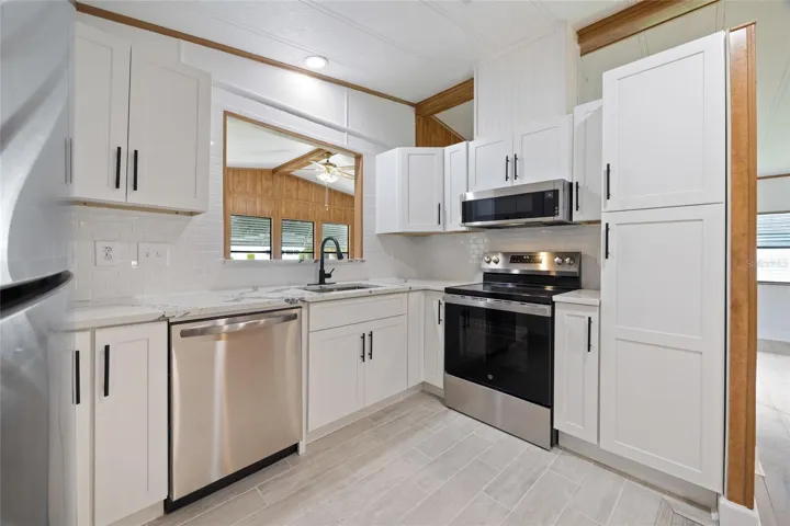 Newly Remodeled Titled Kitchen With Stainless Steel Appliances