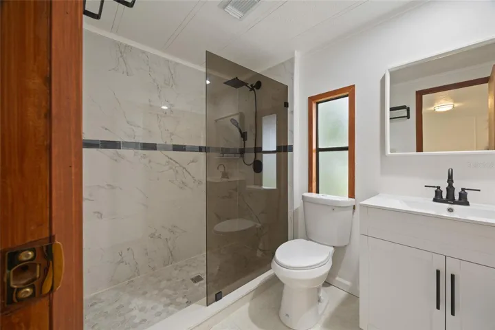 Remodeled Tiled Master Bathroom With A Walk-In Shower
