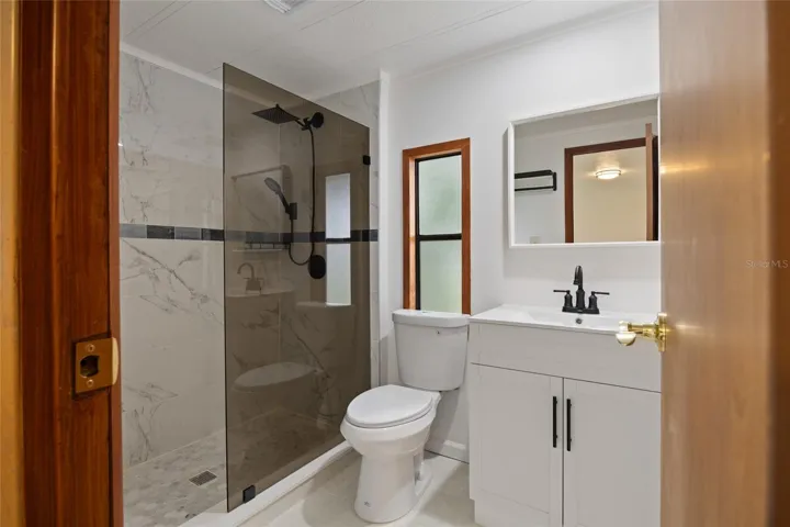 Remodeled Tiled Master Bathroom With A Walk-In Shower