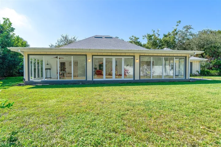Expansive glass doors and windows line the back of the home