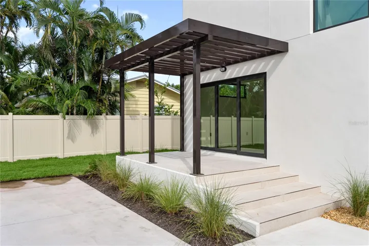 Front patio with elegant trellis detail and direct access to the office through sliding glass doors