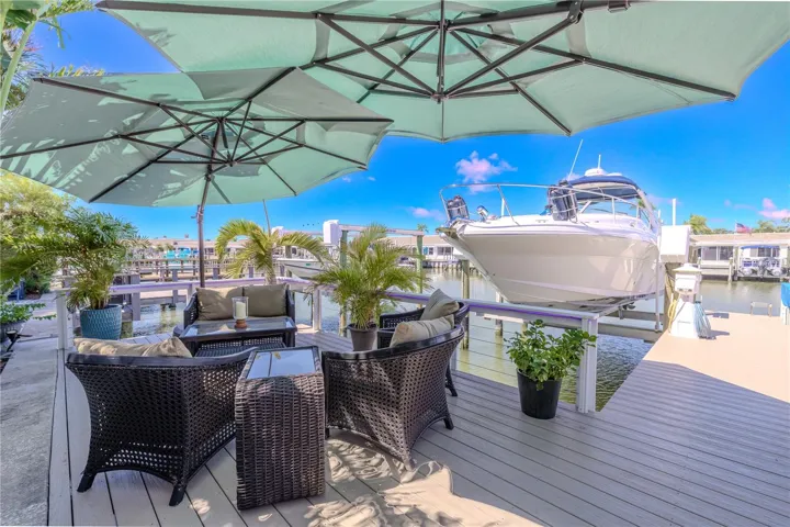 This outdoor oasis overlooks the canal and 16,000-pound boat lift, providing a perfect space to relax and watch the boats drift by.