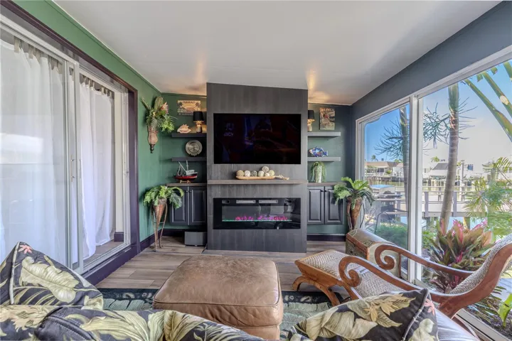 The bonus room offers beautiful water views and built-in shelving that frames a cozy entertainment space with room for a mounted TV.
