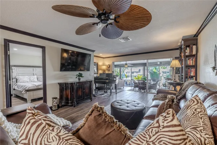 Multiple seating areas in the living room offer flexibility and function, all oriented toward the home’s beautiful waterfront backdrop.