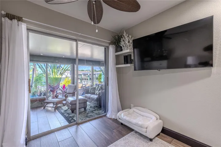 A cozy nook by the sliding glass doors offers the perfect spot for a small office, reading chair, or quiet corner to enjoy the waterfront view.