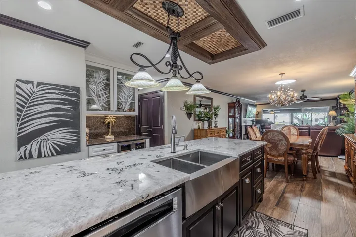 The dual-zone wine and beverage refrigerator provides the ultimate convenience for hosting, complementing the kitchen’s high-end finishes.