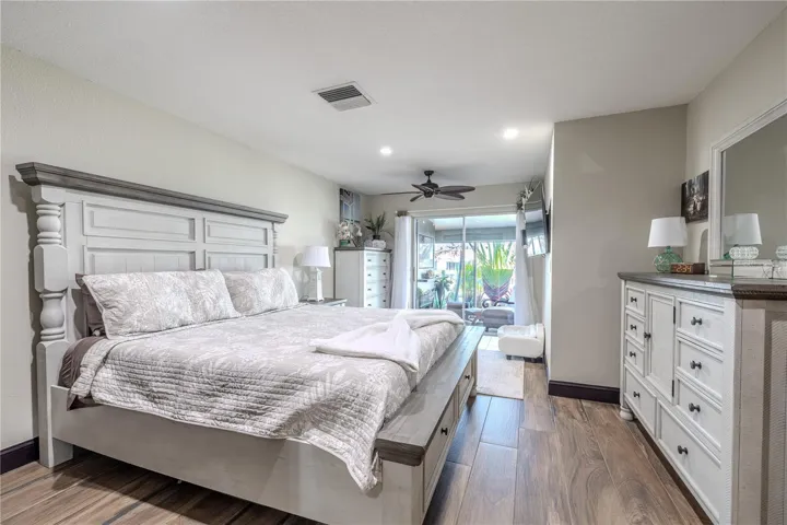 Designed for both comfort and function, the primary suite includes two closets with one featuring custom built-in shelving that maximizes storage space.