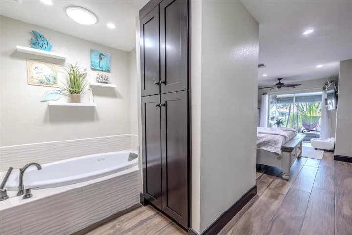 A bright hallway leads from the primary suite toward the main living areas, connecting the private retreat to the open, airy layout of the home.