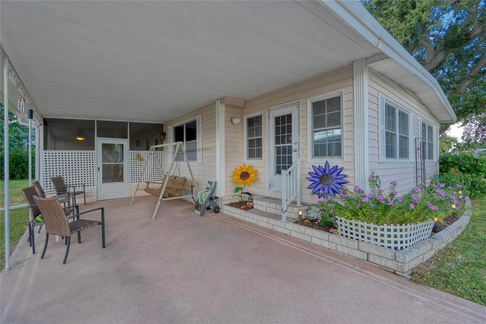 A Carport at the front of this home with an inviting entrance