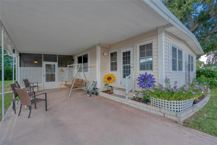 A Carport at the front of this home with an inviting entrance