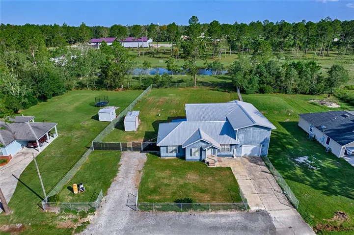 Fenced front yard, two driveways.