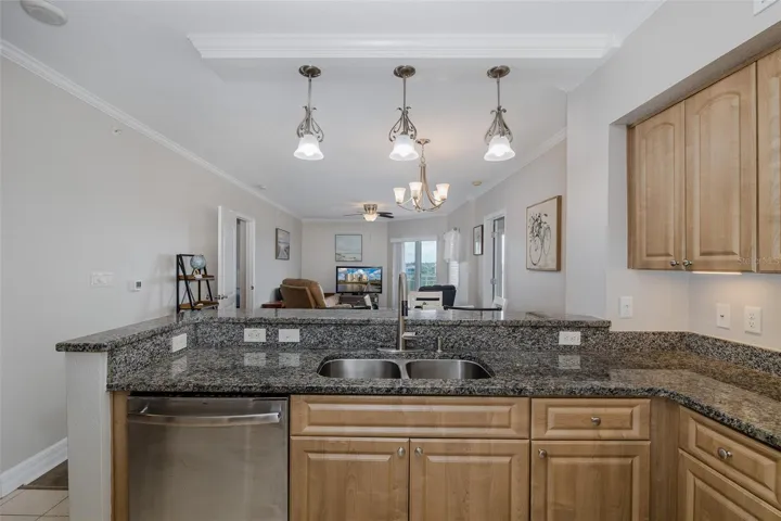 Fourth-floor living and dining area with high ceilings, natural light, and elevator access located steps from the front door.