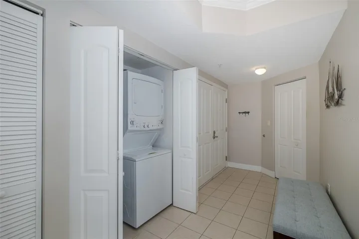 Interior laundry closet with washer and dryer included.