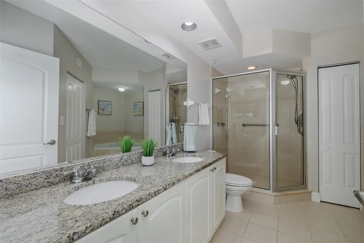 Primary bathroom with dual-sink vanity, garden tub, and separate walk-in shower.