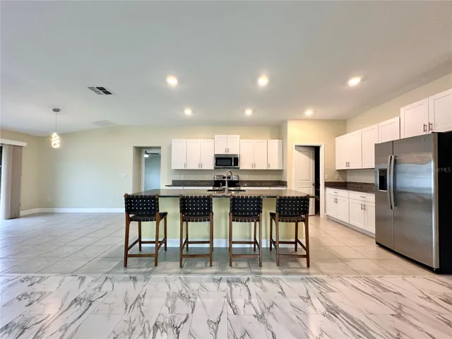 Kitchen opens directly into the main living area — perfect setup for hosting, relaxing, or keeping everyone connected.