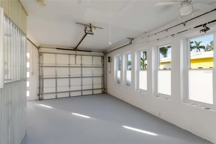 Garage with impact windows and painted floors.