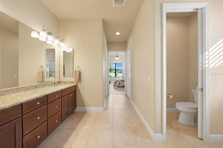 Master bath with private commode, double sinks and large walk-in shower.