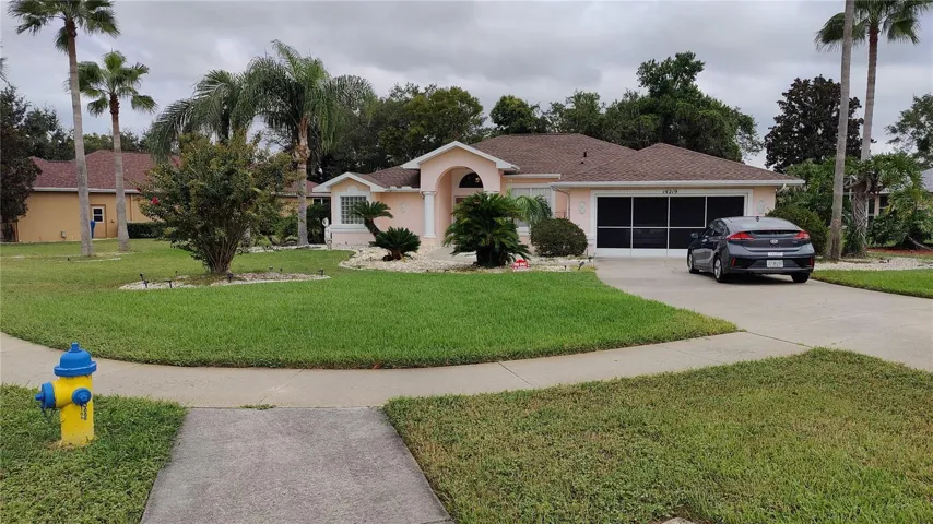Driveway to double car garage which has screen doors to keep your garage cool.  Fire hydrant right in front of house to keep your homeowners insurance premiums low as well as the hip roof design.  community sidewalks makes it safe to walk around to visit neighbors and exercise