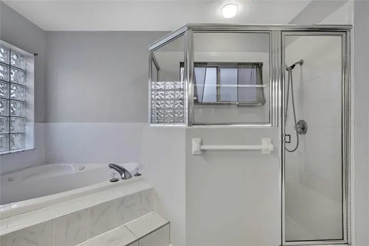 Primary bathroom has jetted garden tub and separate walk in shower.