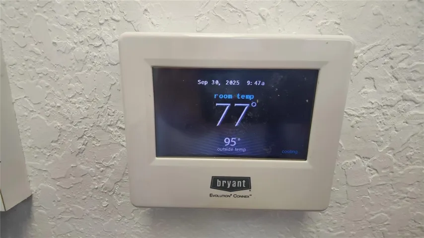 Modern thermostat displays both inside and outside temperature.  Looks like it's time for a swim to cool off.