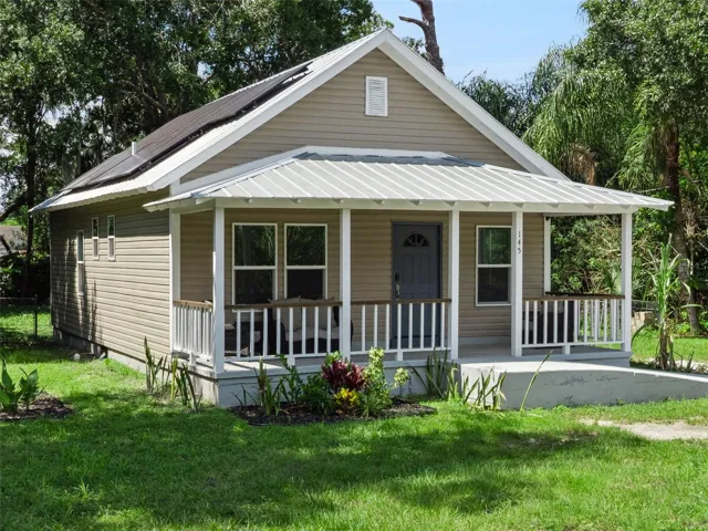 Welcome Home-Front Exterior with Solar Panels – charming updated home with a welcoming porch.