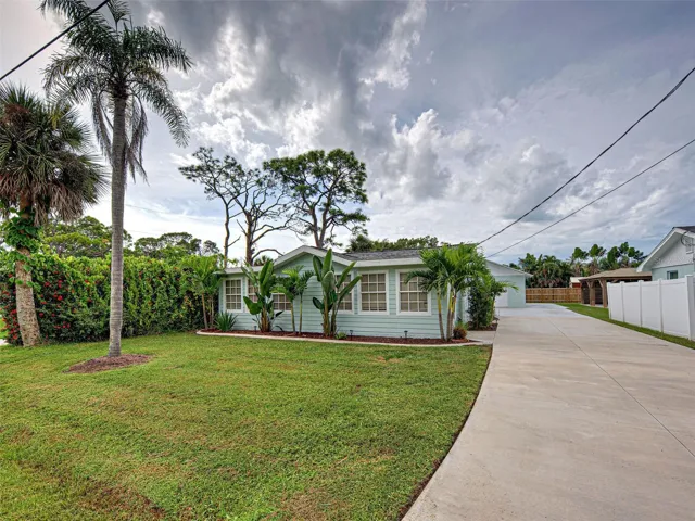 FRONT VIEW - LONG DIRVWAY WITH ROOM FOR RV OR BOAT! DETACHED GARAGE IN BACKGROUND.