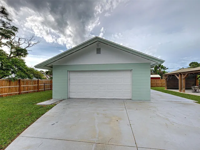 HUGE DETEACHED GARAGE WITH OVERHEAD DOOR.
