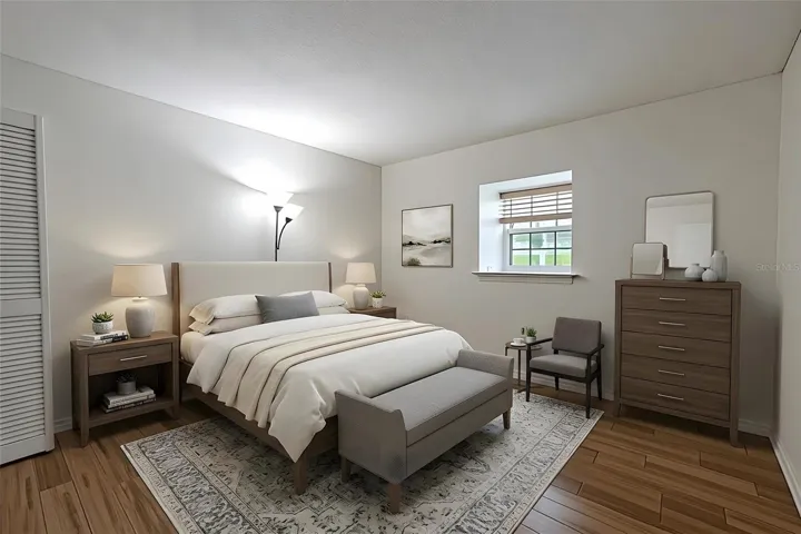 The second bedroom offers a bright and versatile space with warm bamboo flooring and a large double pane window that lets in plenty of natural light. Nuetral walls and clean lines create a crisp, modern feel, while the room’s layout provides flexibility for use as a guest room, home office, or hobby space. A full-size closet adds practical storage