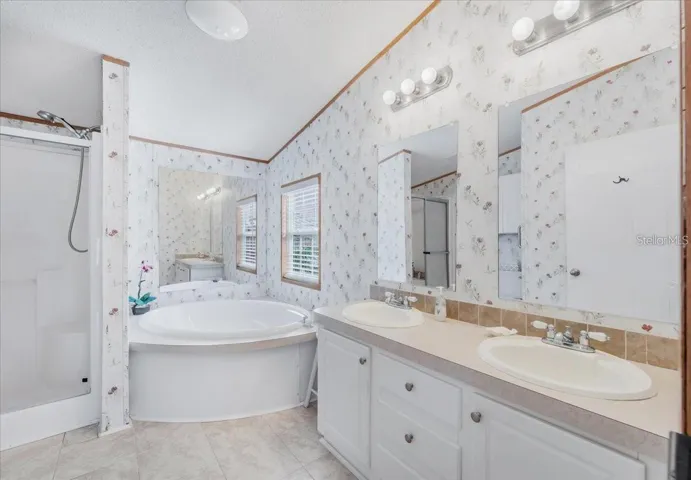 Luxurious Primary Bath Featuring Dual Sinks, Soaking Tub, and Walk-In Shower