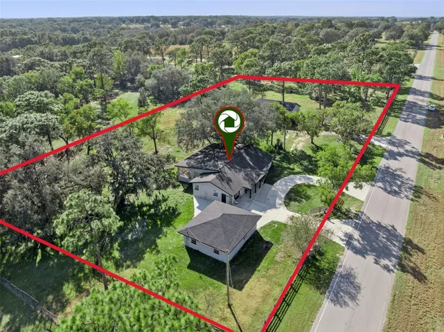 Property view showing main home and detached structures