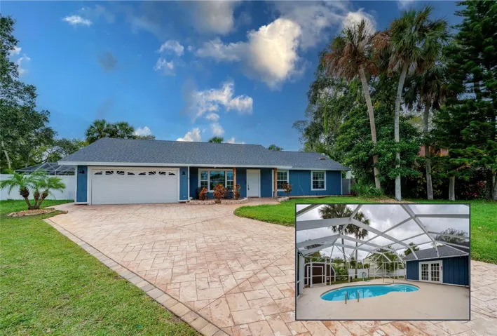 Inviting curb appeal with a stamped concrete driveway, fresh blue exterior, and a charming covered front porch accented by tropical landscaping and mature palms.