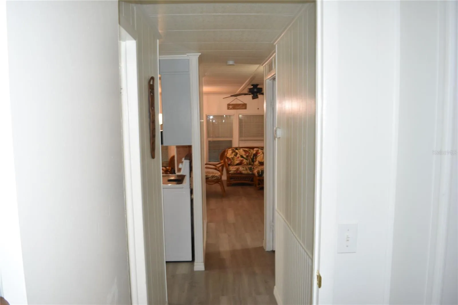 View to kitchen and dining/living room from primary bedroom doorway
