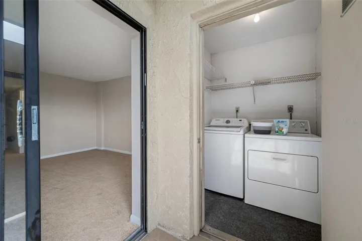 Laundry room with full size washer and dryer included.