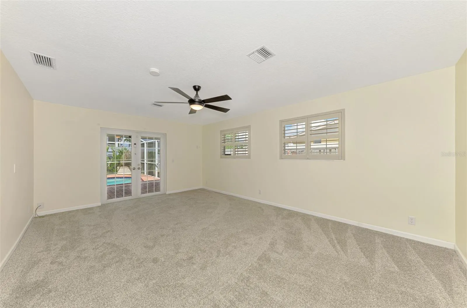 Primary Bedroom, with En suite Bathroom and Walk-in closet, French doors leading out to Pool.